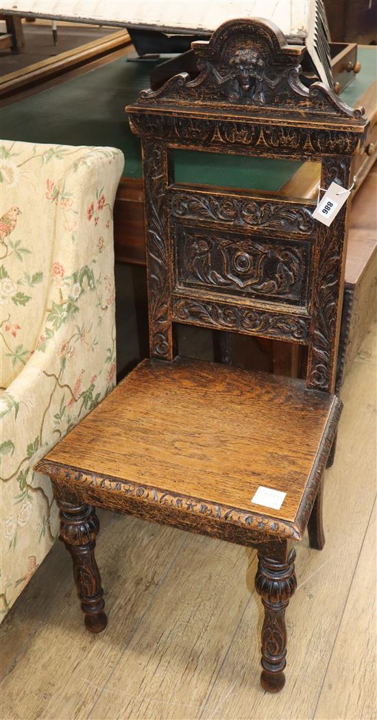 A Victorian carved oak hall chair